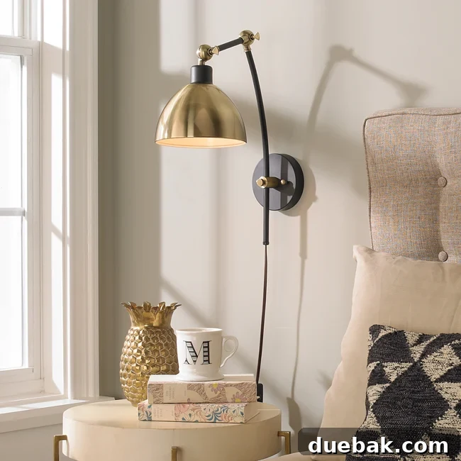 Young House Love dapper adjustable arm wall sconce in mixed finish installed above a bed