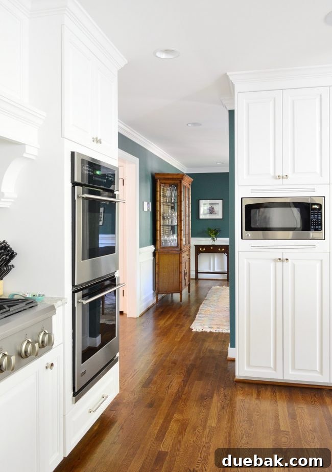 Dining Room with Green-Teal Walls and Hutch