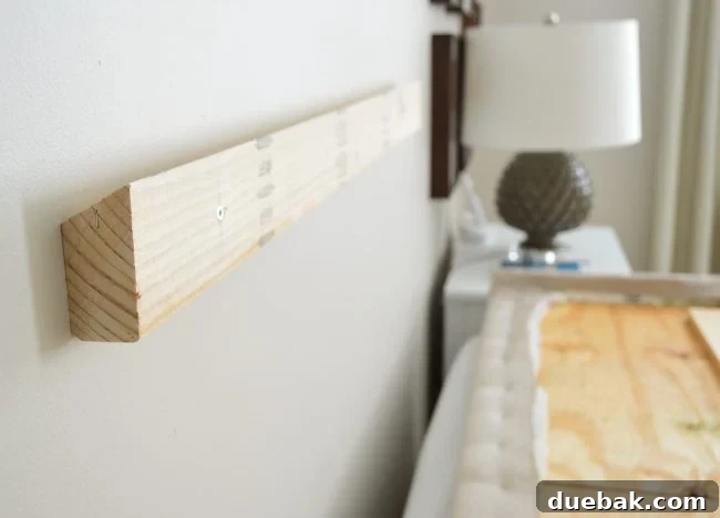 Light Up Your Sleep: Bedroom Refresh with a Chandelier and New Bed 14 Close-up of the cleat system showing two angled boards fitting together.