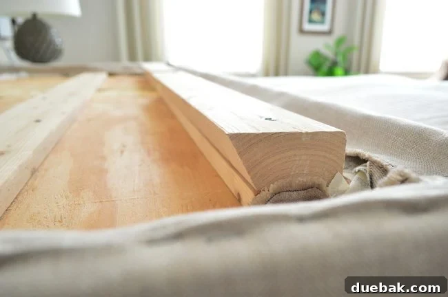 Light Up Your Sleep: Bedroom Refresh with a Chandelier and New Bed 15 Back of the headboard with the second cleat board attached, ready to hang.