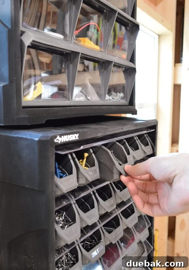 Close-up of pull-out shelves for screws and small parts in a shed