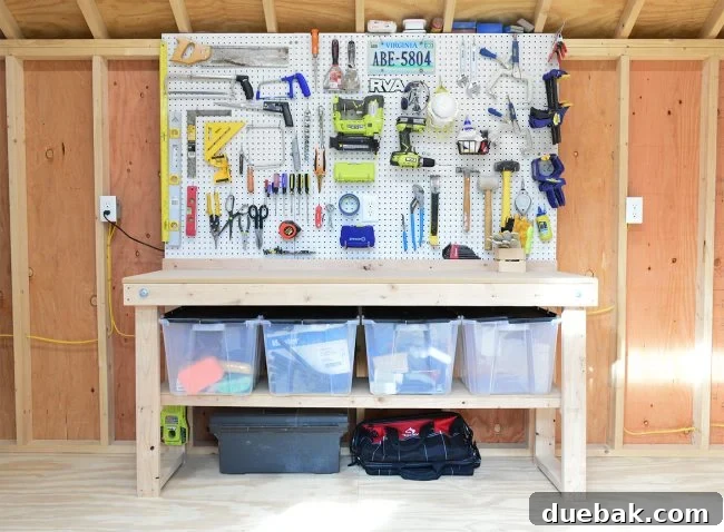 Workbench area with multiple pegboards displaying tools