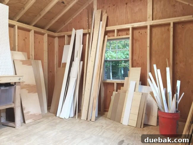 Large pile of scrap lumber in a shed before organization