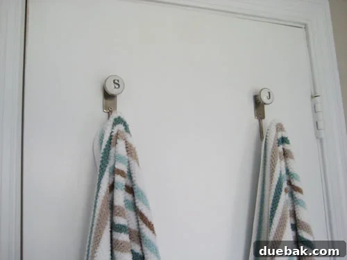 Monogrammed Bathroom Storage Ideas 2 Personalized initial towel hooks in a black and white bathroom, with a 'P' hook visible.