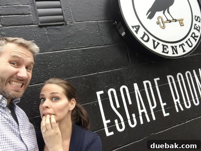 A couple showing nerves in front of an Escape Room sign