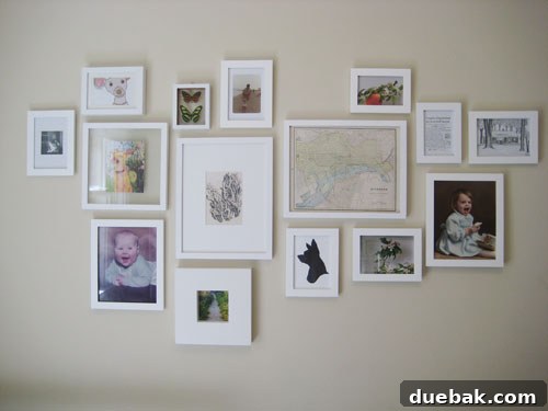 White-framed gallery wall with various black and white art pieces