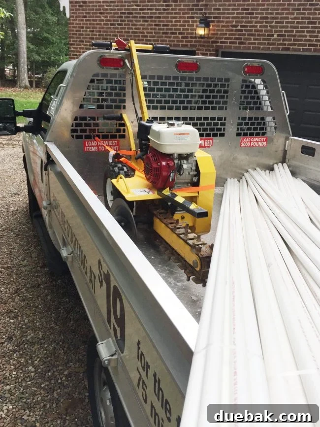 Home Depot rental truck loaded with PVC pipes and a trencher in the back, ready for irrigation project