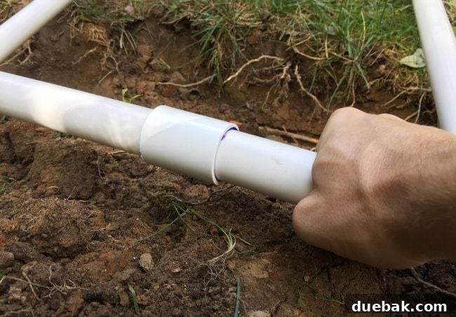 Connecting two PVC irrigation pipes using a coupling and PVC cement for a strong bond