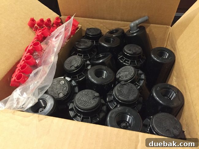 Box filled with numerous Hunter PHP sprinkler heads, ready for irrigation system assembly