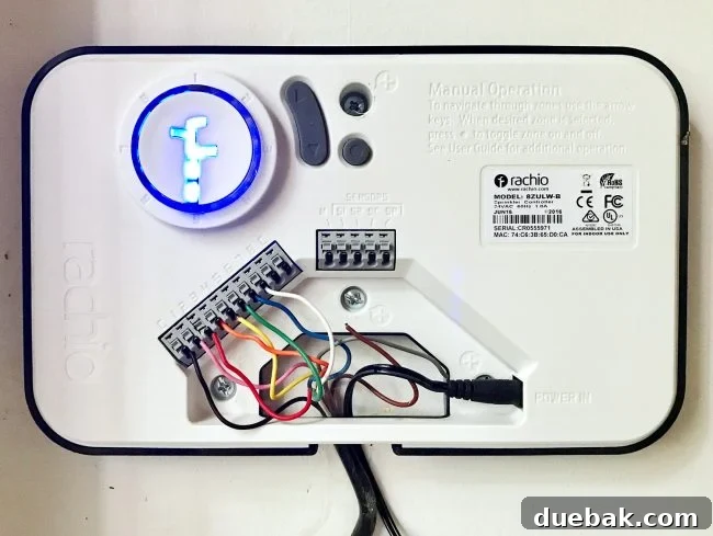 Rachio smart controller with its cover removed, showing the wired connections for an irrigation system