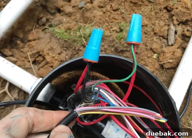 Connecting black common and green zone wire to an irrigation system valve using waterproof caps