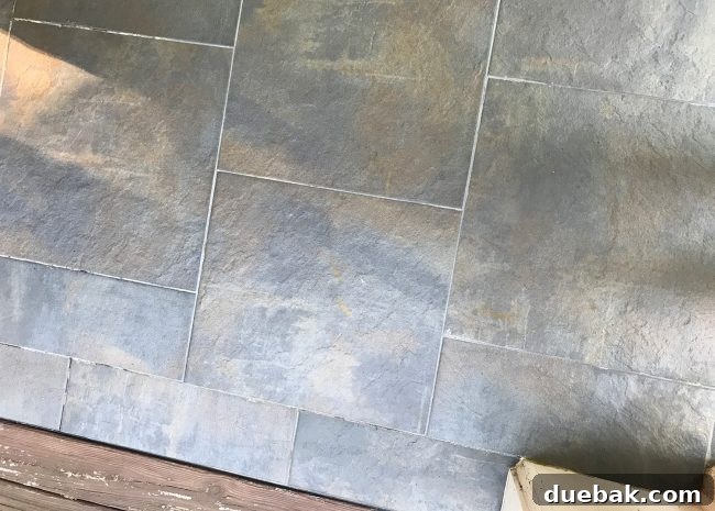 The same corner of the outdoor tile floor, sparkling clean after being pressure washed and dried.