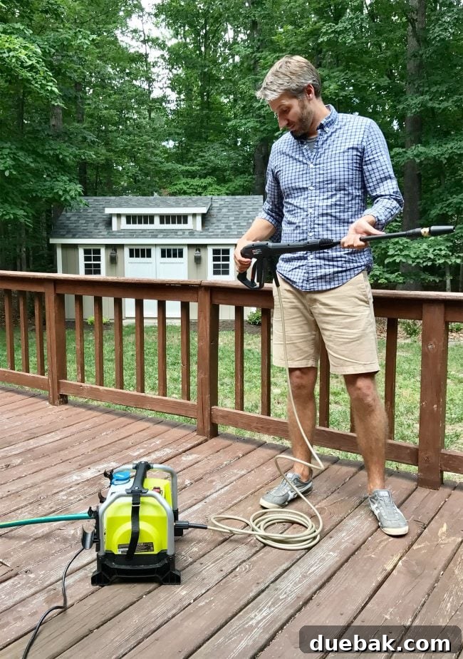 Compact electric pressure washer, neatly set up and ready for use in an outdoor setting.