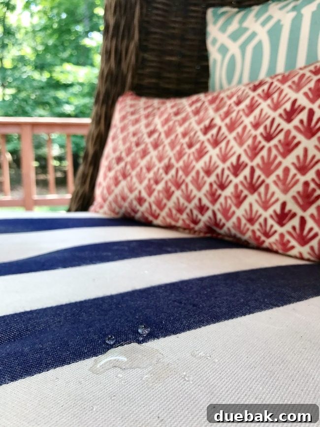 Water beading on the surface of a freshly cleaned outdoor cushion, demonstrating intact water-repellent treatment.