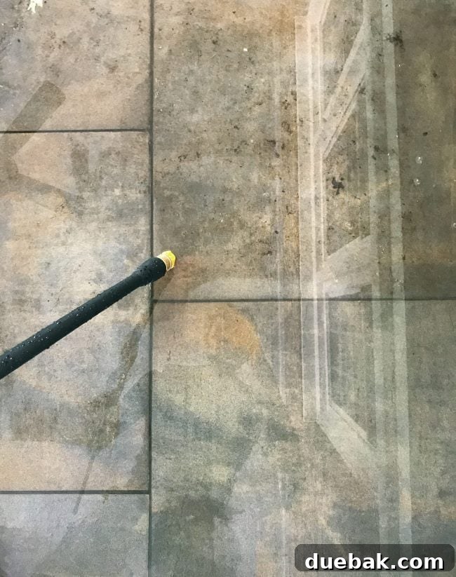 Outdoor tiles showing distinct clean sections and leaf-stained areas, highlighting the impact of hidden debris.