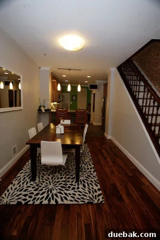 Close-up of the newly installed wood flooring and refreshed baseboards