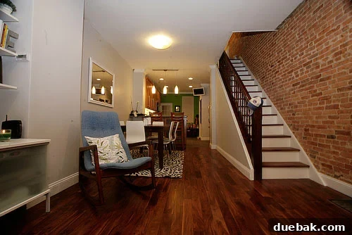 View of an open living area showcasing modern aesthetics and original brickwork
