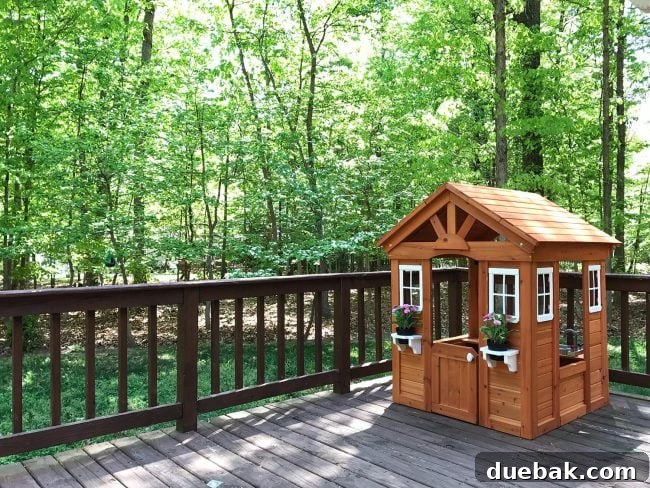 Charming cedar wooden playhouse on a deck, perfect for kids outdoor adventures
