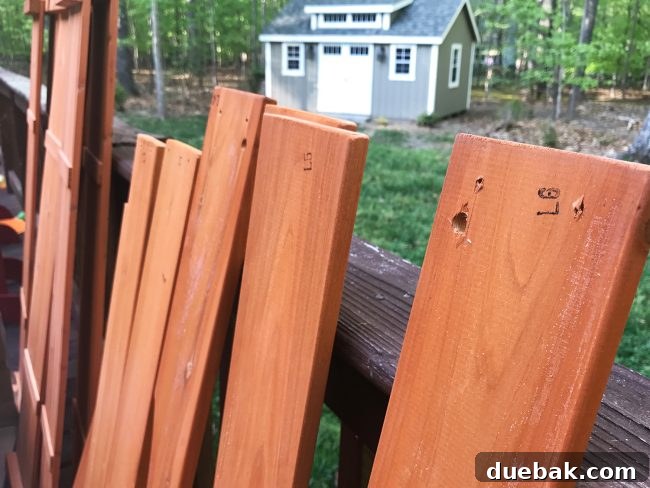 Unassembled cedar playhouse pieces neatly laid out with labels for easy identification