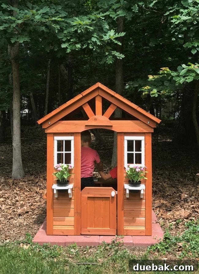 Kids happily playing inside their cedar wooden playhouse, fostering imagination