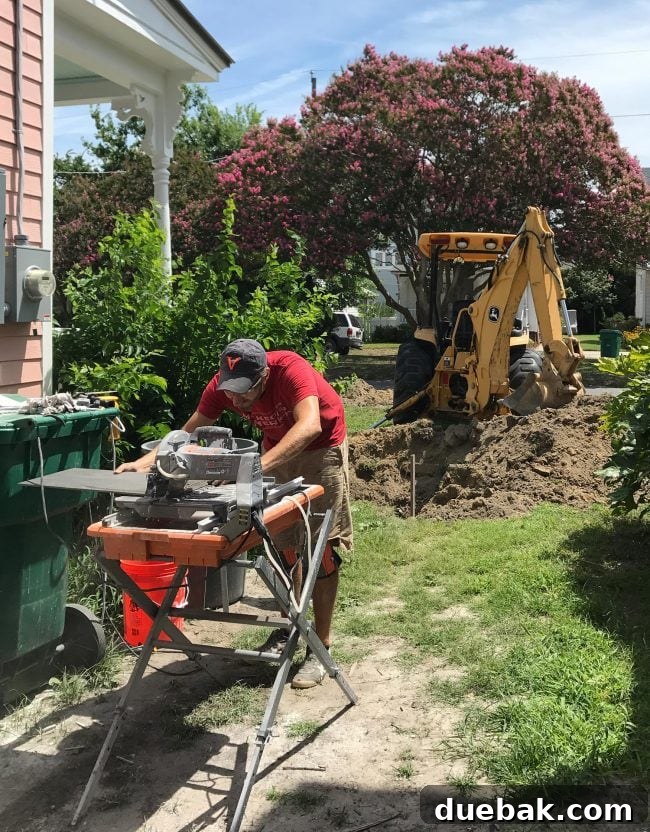 When Home Renovations Bring Sherry to Tears 2 Excavator searching for water line while tiling is underway in a beach house renovation