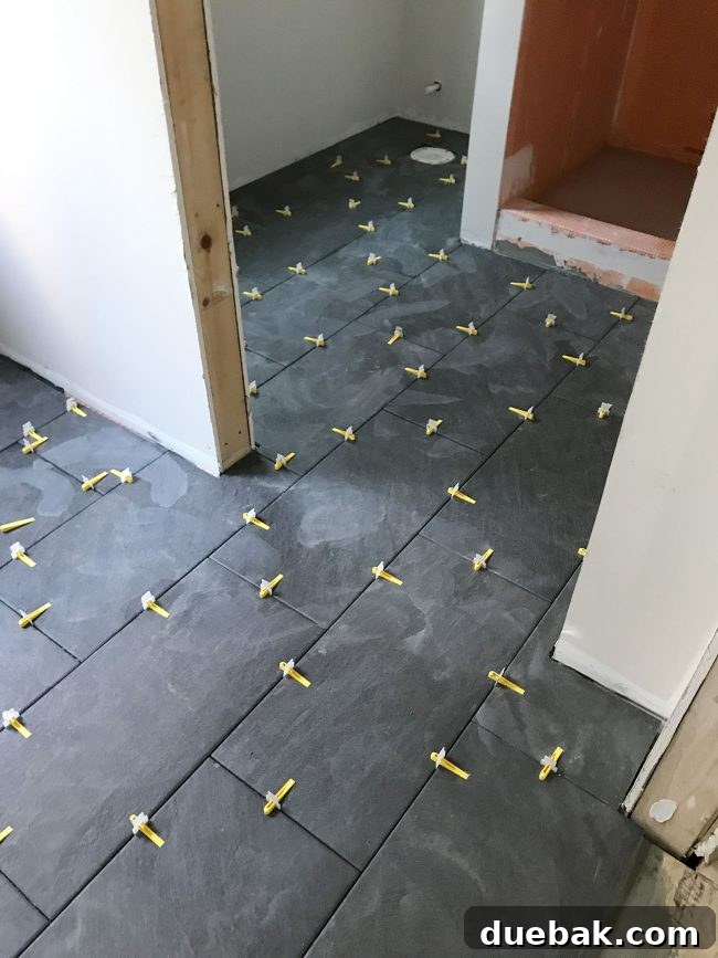 When Home Renovations Bring Sherry to Tears 5 Slate-style tile in downstairs bathroom and mudroom with leveling system wedges visible
