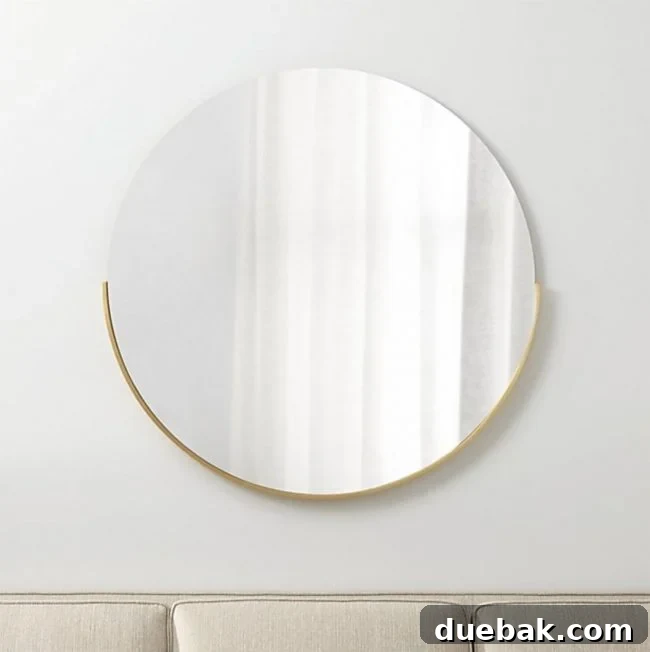 Labor Day Home Refresh: Furniture and Decor Savings 10 Crate & Barrel wall mirror with brass detail and large painterly art piece.
