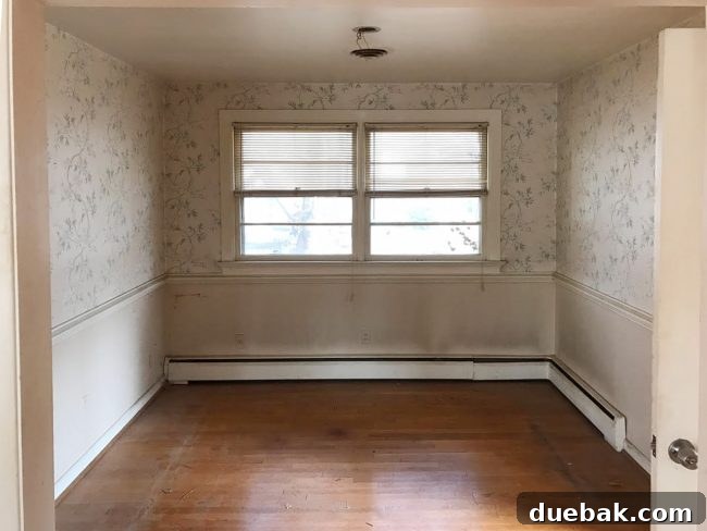 Before photo of a dated dining room with wallpaper