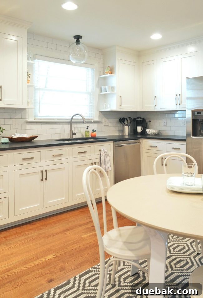 Stunningly renovated kitchen with white cabinets and modern appliances