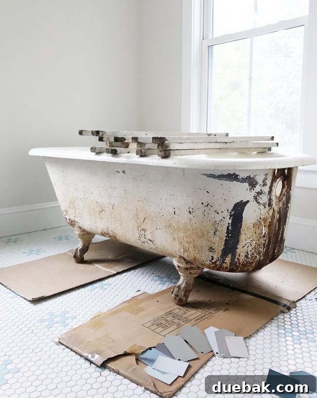 Dirty exterior of a clawfoot tub showing visible rust stains and peeling paint