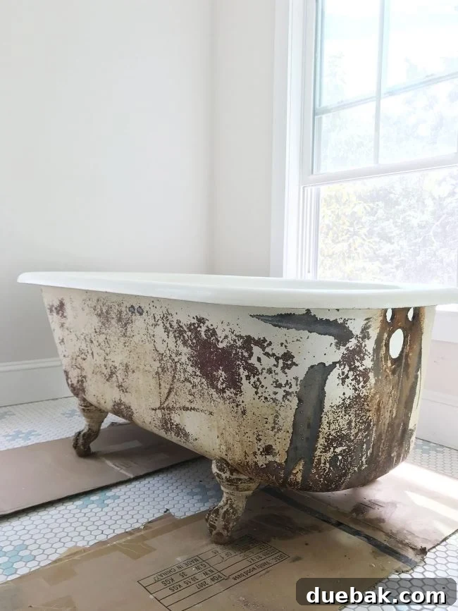 Rust completely removed from the exterior surface of an old clawfoot tub, showcasing a prepared surface