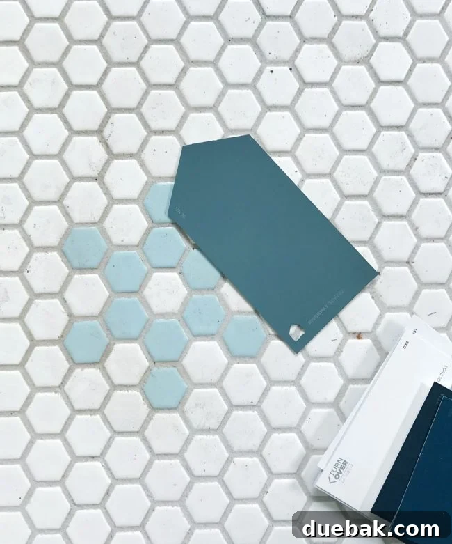 Paint swatch against a blue tile hexagonal floor, showing color consideration