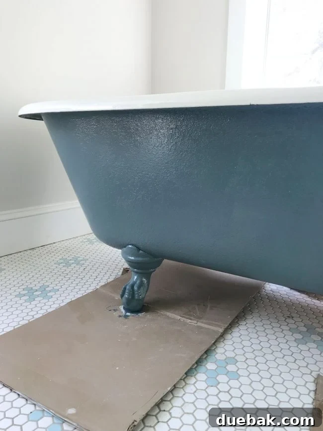 Beautifully painted outside surface of a refinished vintage clawfoot tub in a striking navy blue