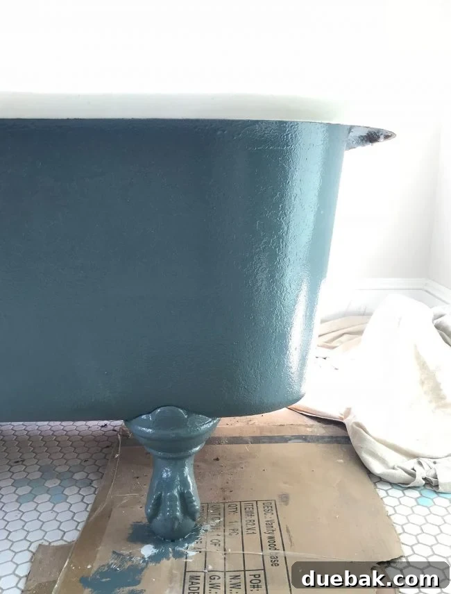 Navy blue painted refinished clawfoot tub standing majestically in the bathroom