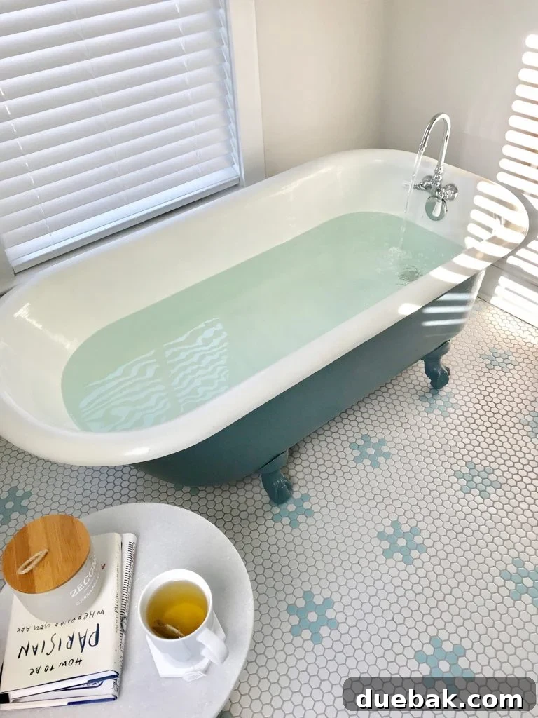 Refinished clawfoot tub brimming with water, inviting a relaxing soak