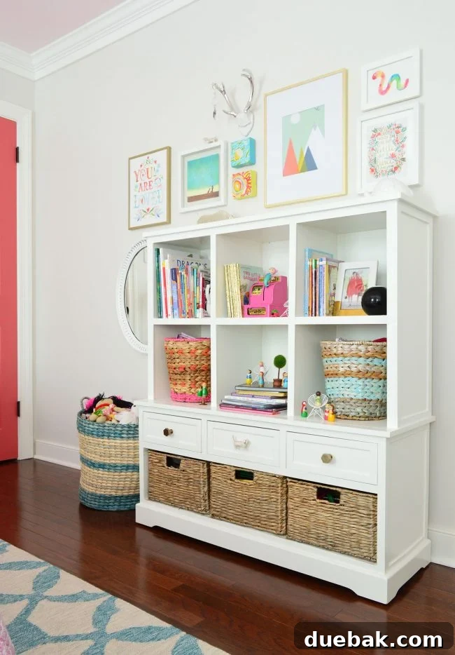 Girls bedroom with updated art wall, storage bookcase, and play area