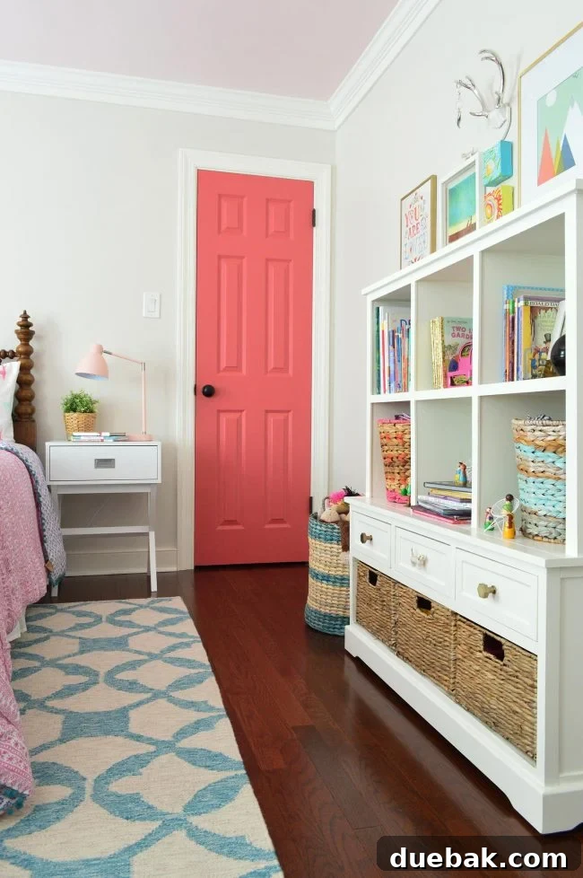 Girls bedroom showcasing toy chest storage and a bookshelf against White Heron walls