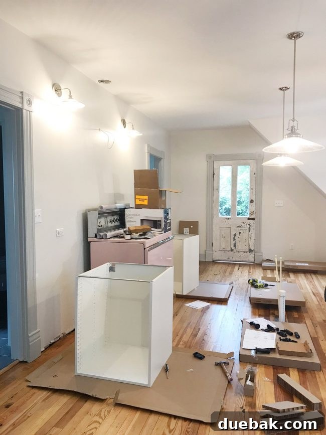 IKEA kitchen cabinets installed in beach house with pink stove