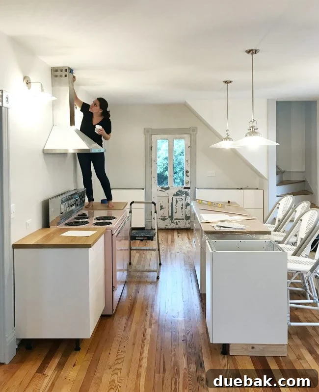 Person on kitchen counter patching a ding in the ceiling