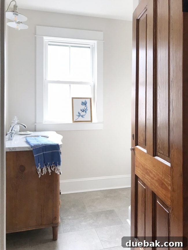 Completed hall bathroom in beach house with shower curtain and fresh caulk