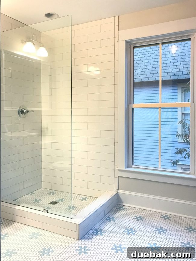 Master bathroom shower with new glass panel and bright, open feel