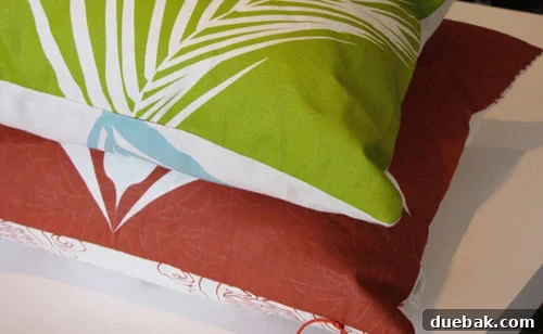 Stacked So'mace Lifestyle Pillows somacepillowstacked1 - A neatly stacked pile of three So'mace Lifestyle pillows, showcasing their unique reversible designs and high-quality linen texture.