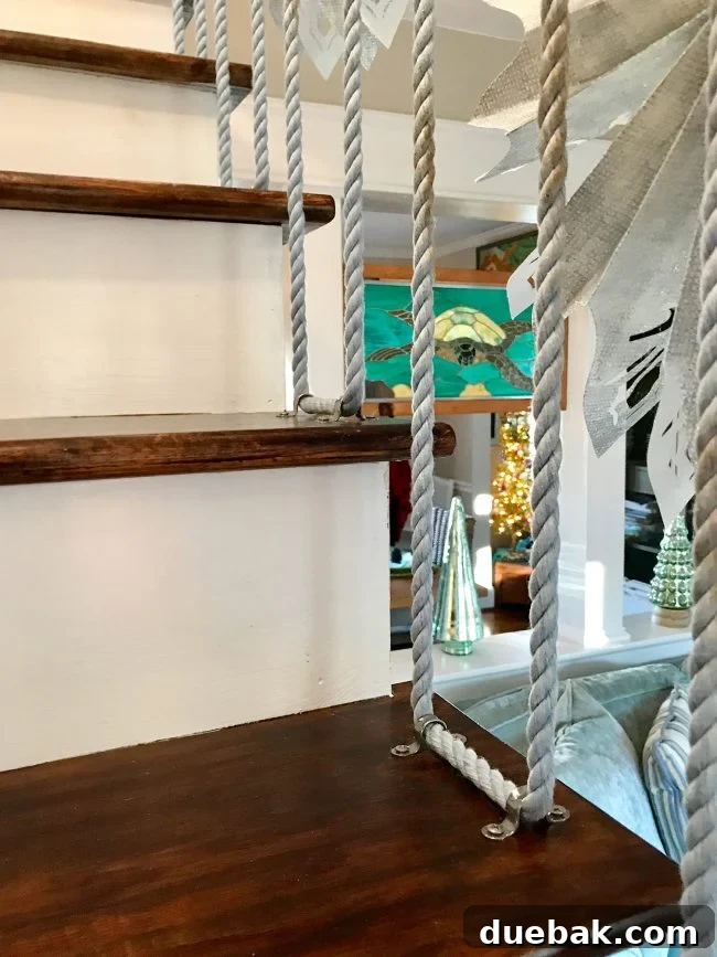 A unique rope railing winding up a staircase, secured with steel clips
