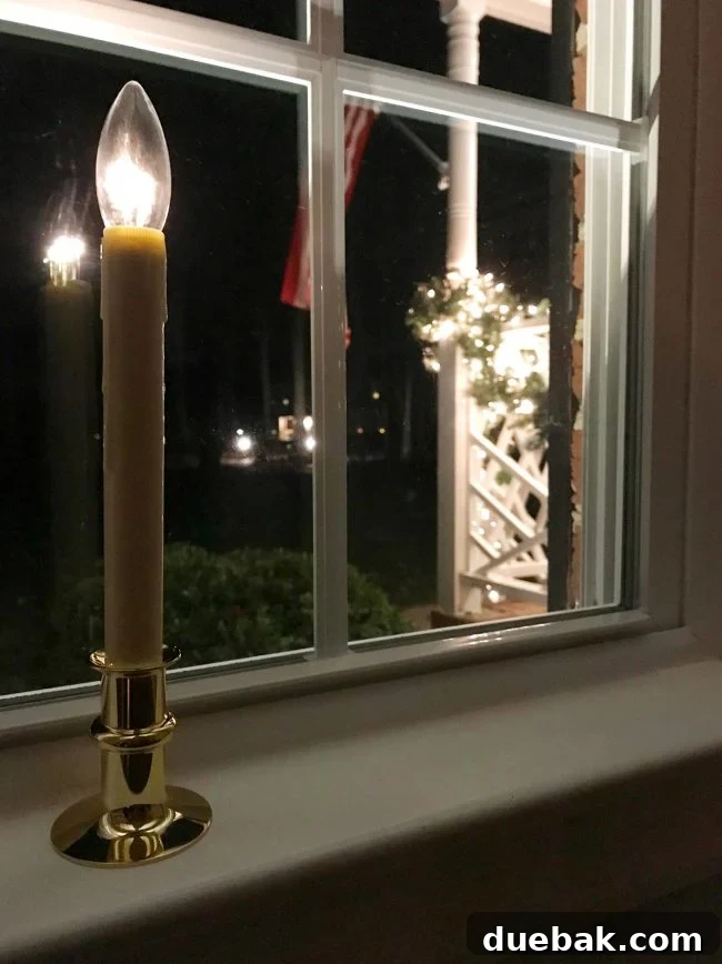 LED Streetside Brightness Cordless Window Candles glowing in a window, providing an automatic festive display.