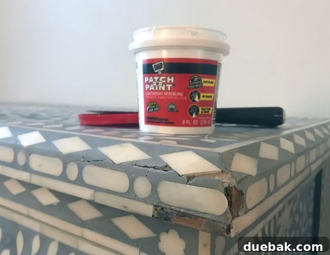 repair inlay on broken and cracked dresser with spackle