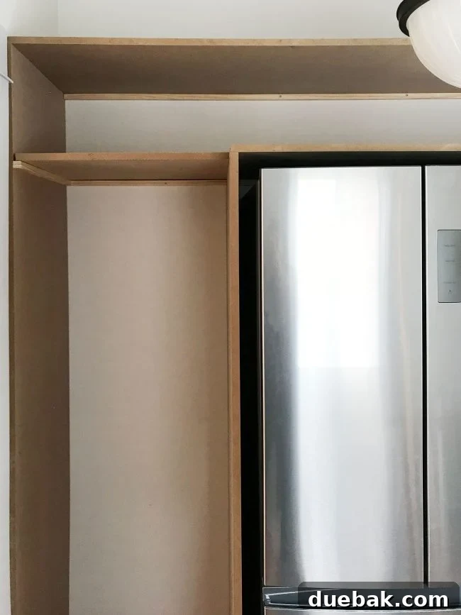 front view of pantry shelves with top shelves already added