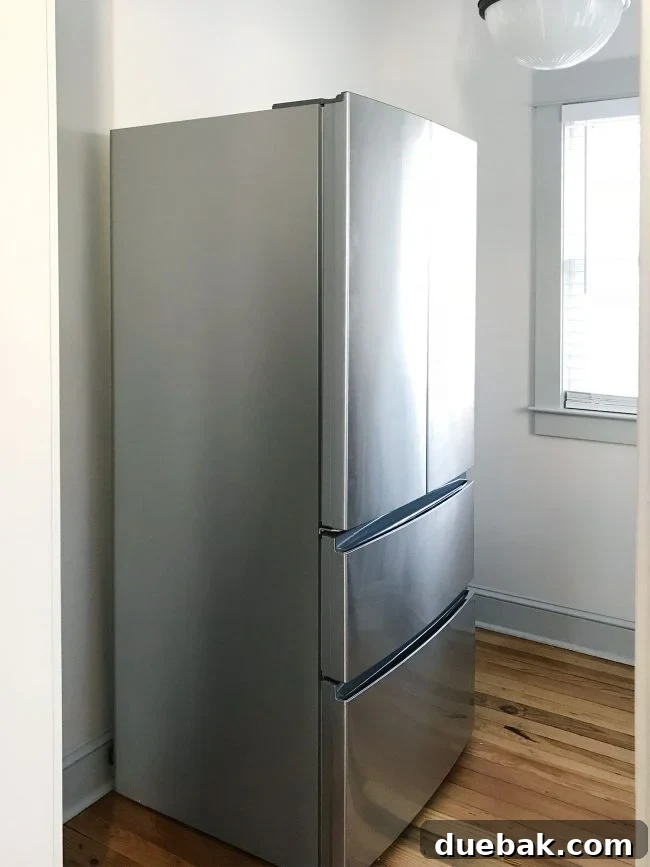 apartment size refrigerator in walk in pantry before shelves