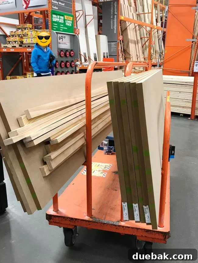 cart full of MDF and wood pieces for pantry shelf project