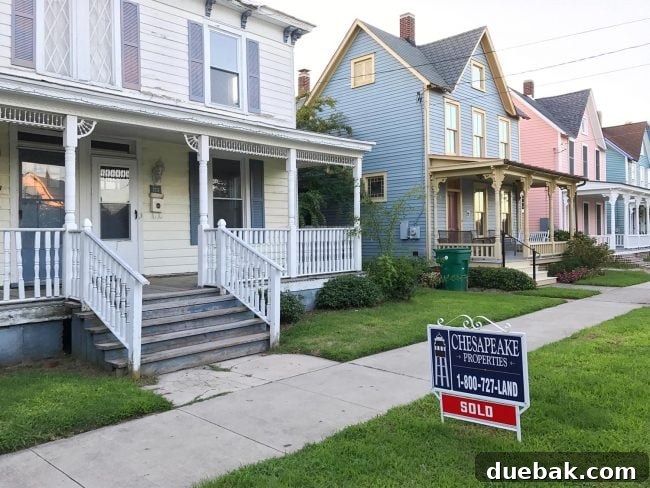 Renovation Rage 3 Sold sign in front of a historic beach duplex on a charming street in Cape Charles Virginia