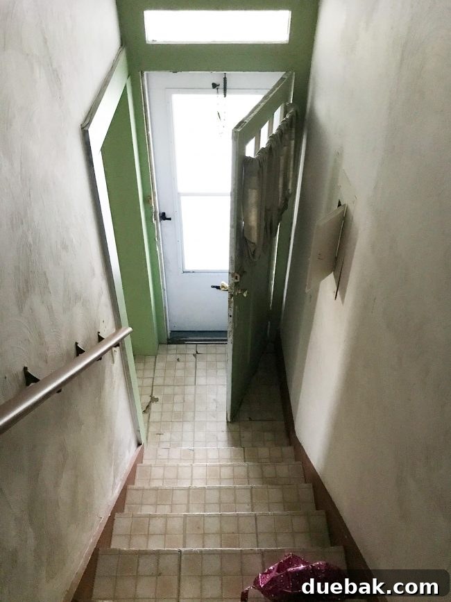 Renovation Rage 4 Before photo of a dilapidated stairwell in a historic duplex undergoing renovation